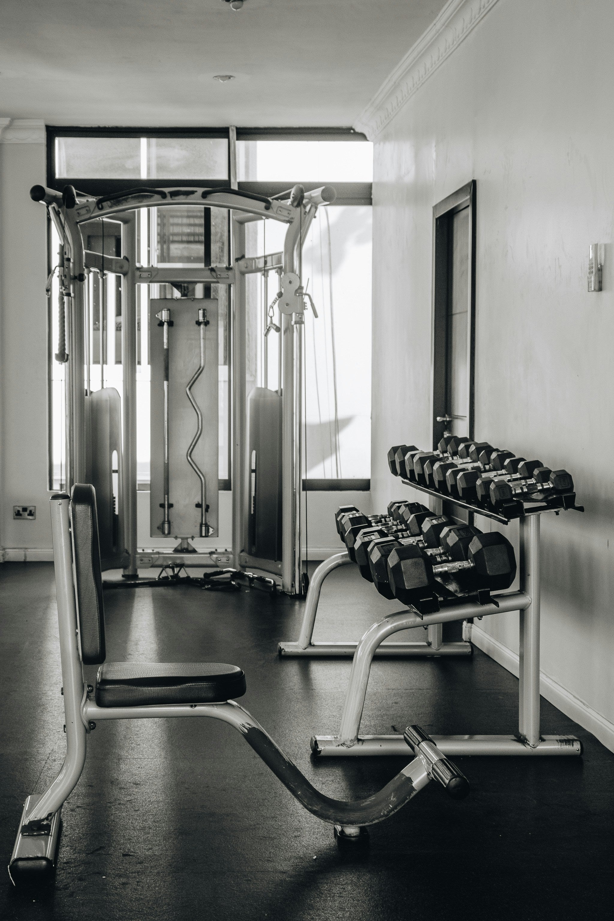 Black and white gym interior with weights and equipment